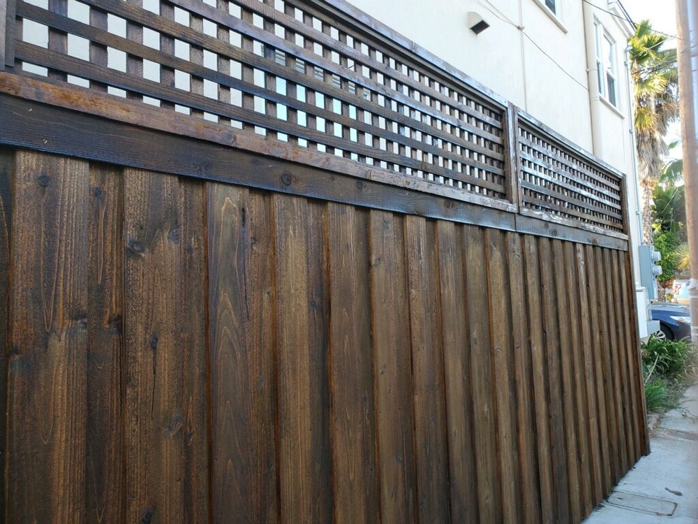 Board-on-board cedar fence with lattice top by HD Fence