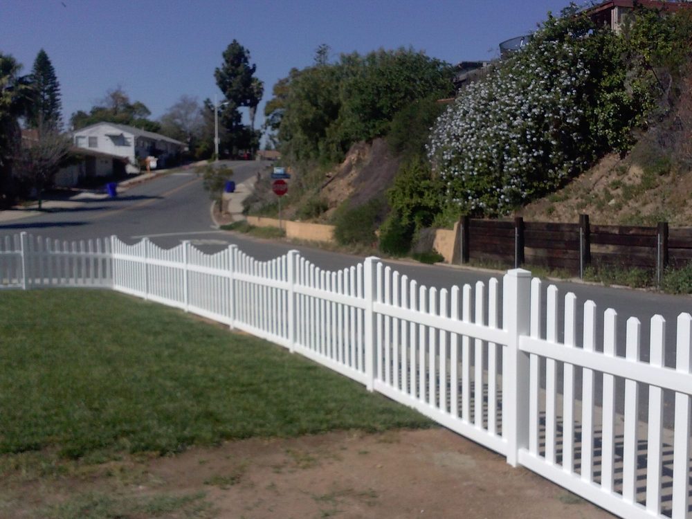 Scalloped white vinyl picket fence installed by HD Fence