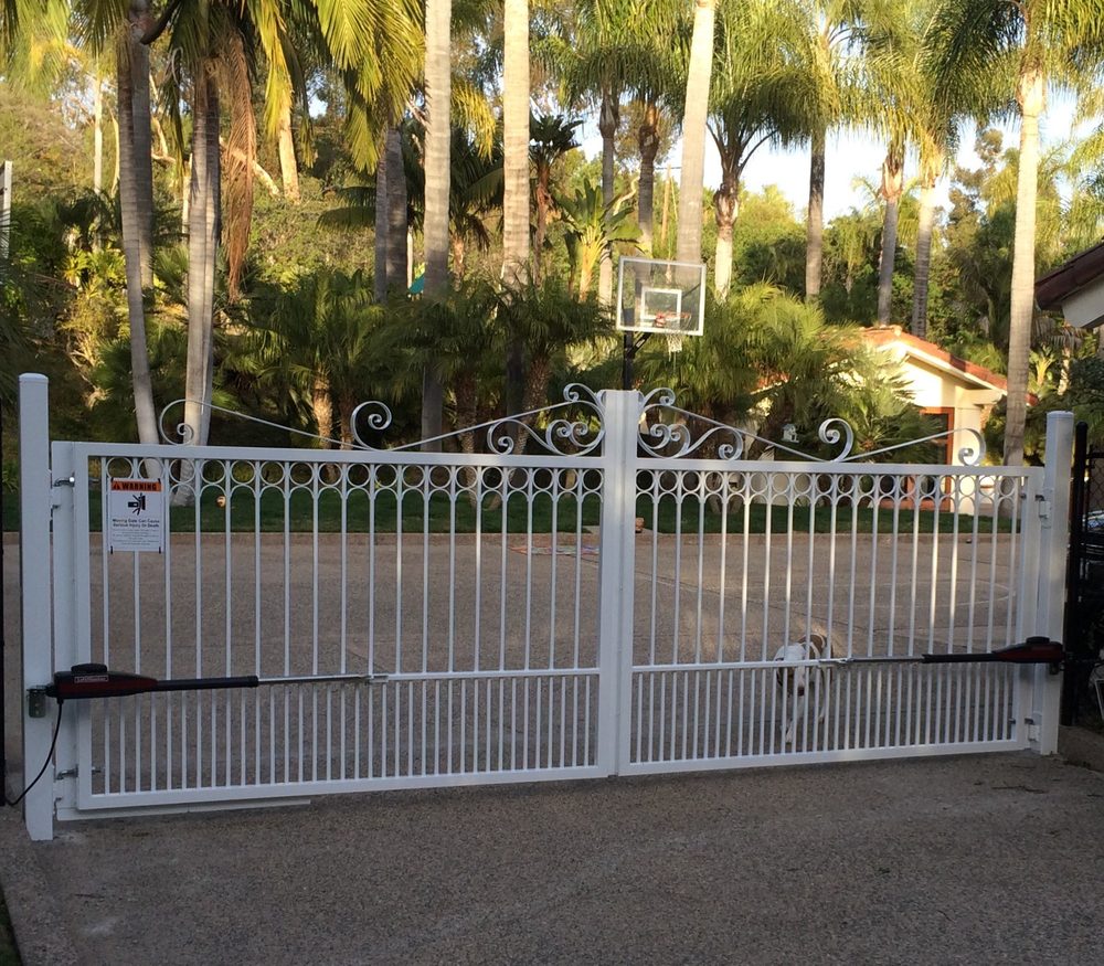 White ornamental iron fence enclosing a basketball court