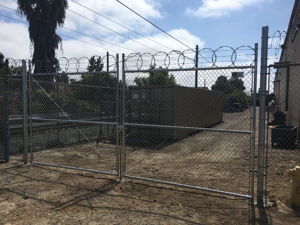 Chain link gate with barbed wire for a secure yard
