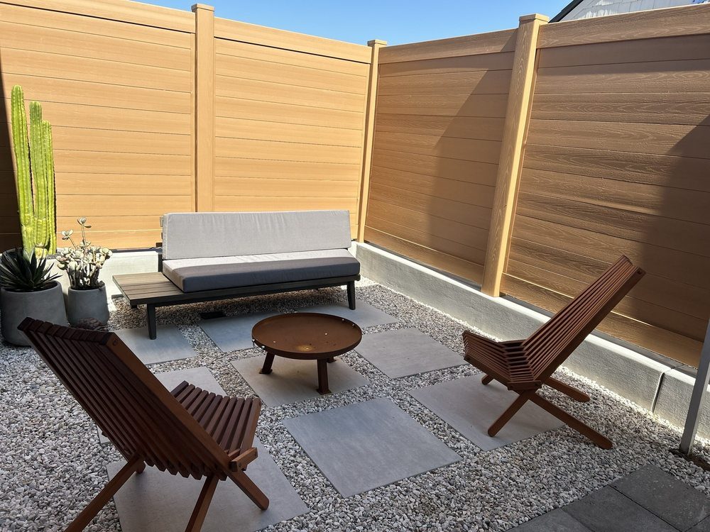 Tan slat fence enclosing a modern patio by HD Fence
