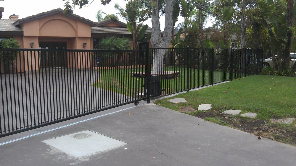 Automated iron driveway gate with operator installed by HD Fence